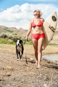 woman on beach with dog