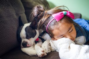 child sleeping with pup